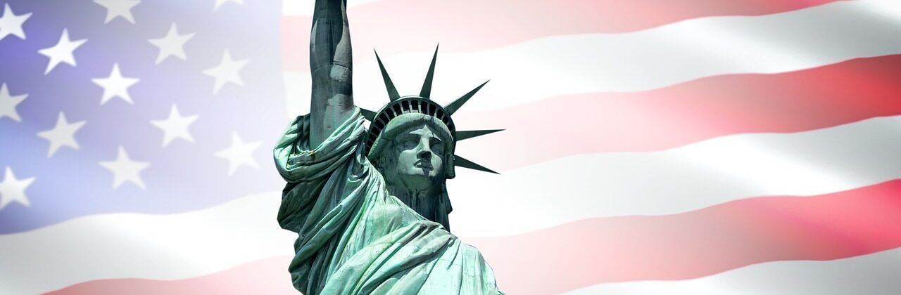 Statue of Liberty in front of American flag